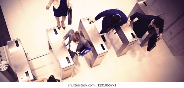 Top view of business executives passing through turnstile gate - Powered by Shutterstock