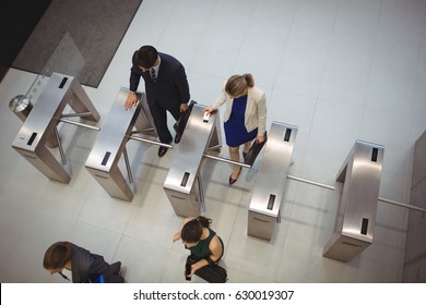 Top view of business executives passing through turnstile gate
