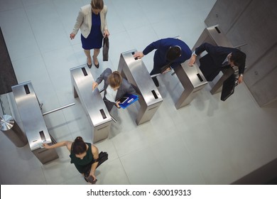 Top view of business executives passing through turnstile gate - Powered by Shutterstock