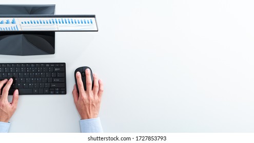 Top view of business man using spreadsheet. Blue graphs on desktop computer screen.  - Shutterstock ID 1727853793