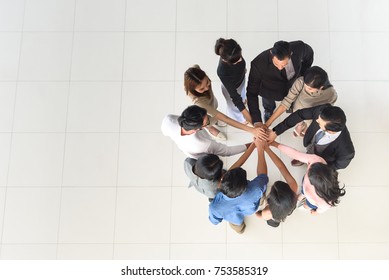 Top View Of Business Multi-ethnic Partners Teamwork, Team Join Hand Together At Office, Synergy Concept, Copy Space