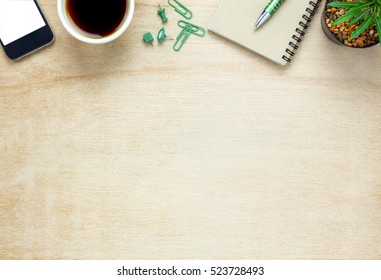 Top View Business Office Desk.notebook,pencil,black Coffee,tree,mobile Phone,paperclips On Wooden Table Background.