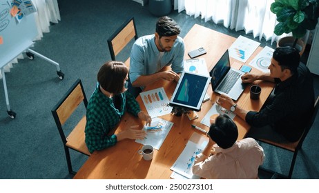 Top view of business people discuss idea while marketing team joining meeting. Manager pointing financial graph while colleagues talking to investor by using phone and brainstorm idea. Convocation. - Powered by Shutterstock