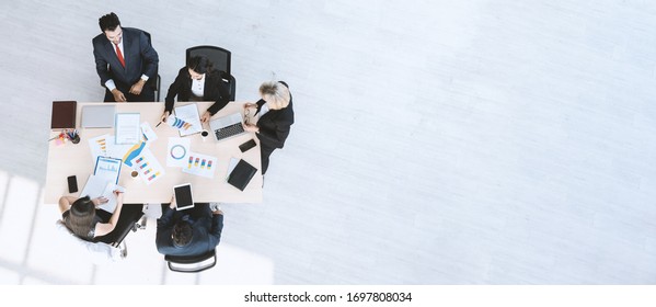 Top View Of Business People Had Meeting And Discussing On Progress Report Of Work In The Modern Office Building.