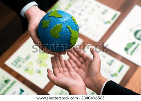Top view business people holding Earth together in synergy as team building to utilize eco regulation for environmental protection by reducing CO2 emission to save Earth. Quaint