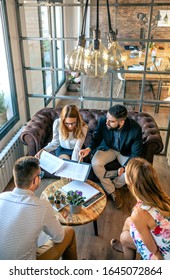 Top View Of Business People In An Informal Work Meeting Sitting On The Couch