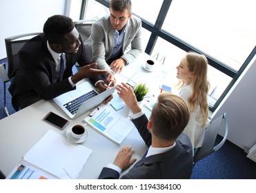 Top view of business people working together while spending time in the office.