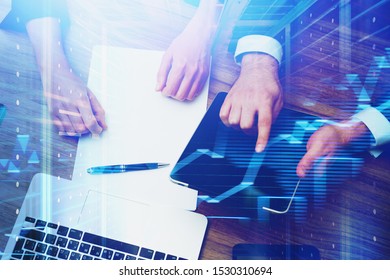 Top View Of Business People Working With Tablet And Laptop At Office Table With Double Exposure Of Graphs And Server Room. Concept Of Coding And Smart Things. Toned Image