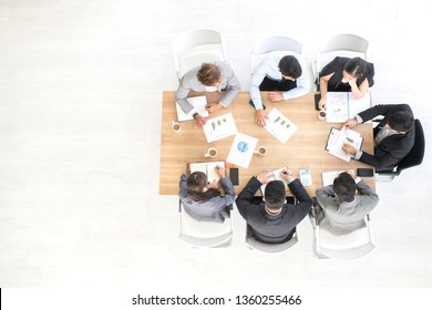 Top View Of Business Team Meeting At Modern Office. Directly Above View Of  Marketing Team. Team Work Concept