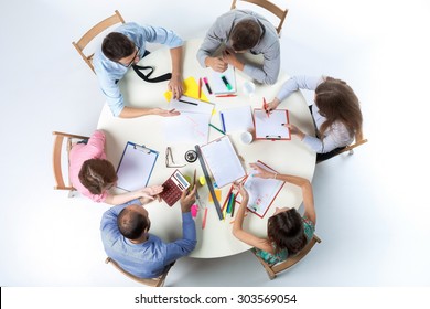 Top View Of Business Team, Sitting At A Round Table On White Background. Concept Of Successful Teamwork