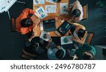 Top view of business team working together while talking about financial chart. Close up of skilled marketing team sharing idea and looking at stock market statistic chart at boardroom. Convocation.