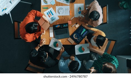 Top view of business team working together while talking about financial chart. Close up of skilled marketing team sharing idea and looking at stock market statistic chart at boardroom. Convocation. - Powered by Shutterstock