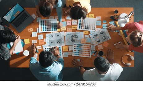 Top view of business team write graphic logo on meeting table with colorful sticky notes and design while explain idea. Project manager sharing idea and explain concept art to smart team. Symposium. - Powered by Shutterstock