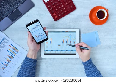 Top view of businessman using tablet and smartphone and checking stock market data. Success and startup concept. Close up