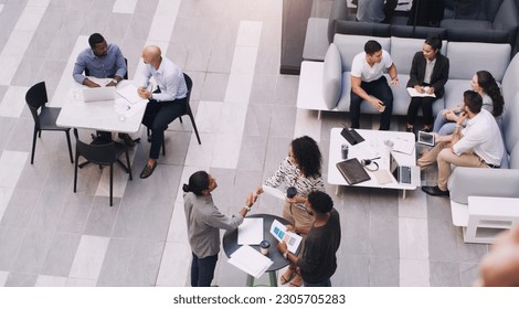 Top view, businesspeople talking and meeting at a conference at their office space. Diversity at work, communication or collaboration and networking or event planning have a conversation together