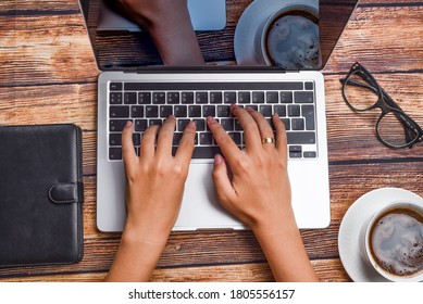 Top view businesswoman typing on laptop at workplace. Woman working in home office hand keyboard. Workplace concept