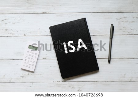 Top view of calculator,pen and notebook written with ISA (individual saving account) on white wooden background.