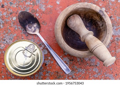 Top view of a can of packaged food, a wooden mortar and a metal spoon on a spotted background - Powered by Shutterstock