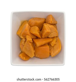 Top View Of Canned Yams In A Square Bowl Isolated On A White Background. 