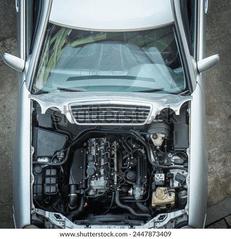 Top view of car engine bay. Motor, mechanical and electrical components under hood. Repair and maintenance auto