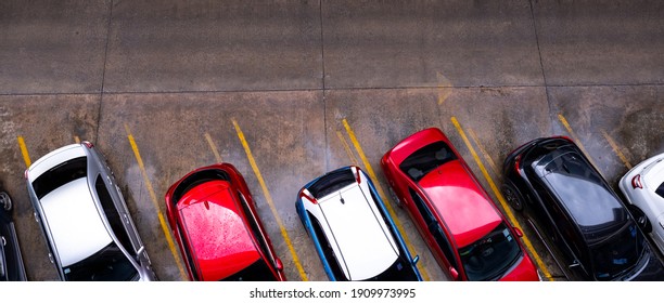 Top View Of Car Parked At Concrete Car Parking Lot With Yellow Line Of Traffic Sign On The Street. Above View Of Car In A Row At Parking Space. No Available Parking Slot. Outside Car Parking Area. 