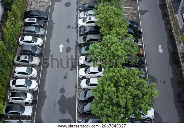 Top view of cars in the car park. Background\
of cars in car parking lot after\
rainy.