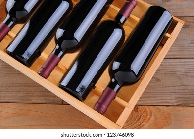 Top view of a case of cabernet sauvignon wine bottles. Horizontal format with a rustic wood background.