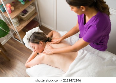 Top View Of A Caucasian Older Woman Getting An Oil Massage To Relieve Back Pain