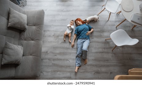 Top view of caucasian woman lying on floor with son and jack russell terrier dog.  - Powered by Shutterstock