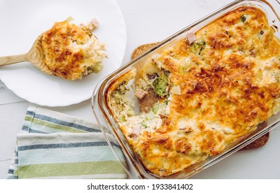 Top View Of Cauliflower, Broccoli And Cheese Casserole In Rectangular Shape Glass Baking Dish.