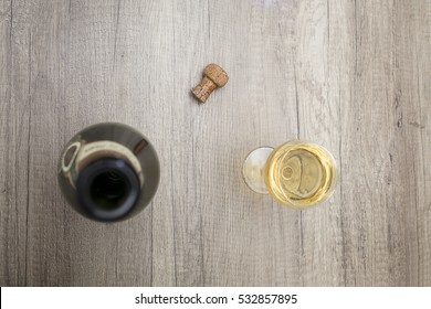 Top View Of A Champagne Bottle, A Glass And A Cork