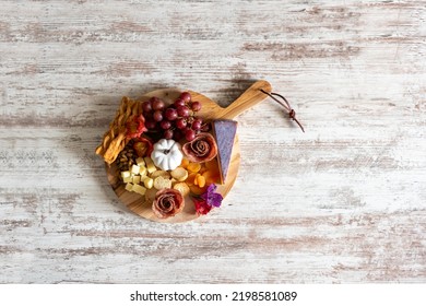 Top View Of A Charcuterie Board On A White Rustic Wood Background