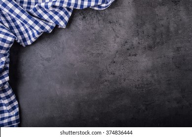 Top View Of Checkered Kitchen Tablecloth On Concrete Background.