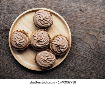 Top View Cheesecake With Chocolate Chantilly Cream On Wooden Table.