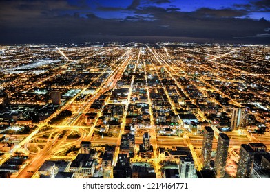 Top View Of Chicago City From Willis Tower, Sky Deck. During Sunset, City Is Full Of Light. Skyscraper Were Built Endlessly.