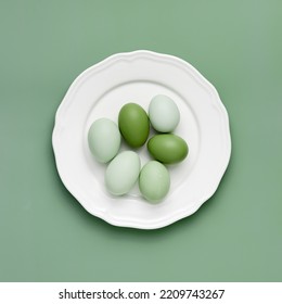 Top View Of Chicken Eggs On White Plate. Minimal Style Lime Green Color Natural Eggs On Colored Background. Useful Eggs With Monochrome Colored Eggshells, Easter Design Concept. Pastel Color, Flatlay.