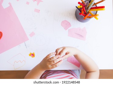 Top View Of A Child Working On Her Project On The Table With Scissors, Markers And Color Paper.Children Art And Creativity Concept. Preschooler Making A Craft At Home.