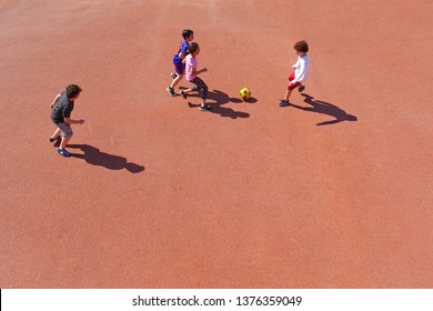 Top View Of Children Playing With The Ball In The Yard. Genoa, Italy - April 2019