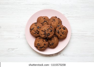 Top View, Chocolate Chip Cookies On A Pink Plate. White Wooden Background. From Above. 