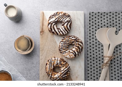 A Top View Of Chocolate Cream Donuts On A Messy Kitchen Table