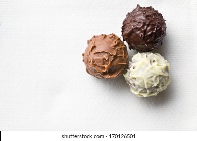 Top View Of Chocolate Truffles On White Tablecloth