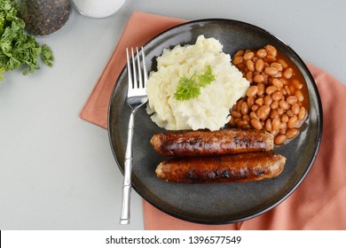 top view chorizo sausages with mashed potato and baked beans