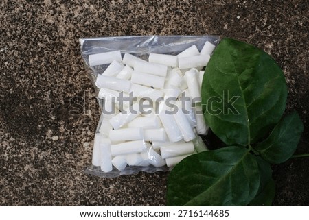 Top view of cigarette filter packaging outdoors.