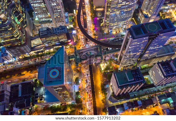 Top view city , Aerial view road , Expressway\
with car lots in the city in Thailand. Beautiful Street at\
downtown.Road roundabout.