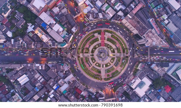 Top view city , Aerial view road , Expressway with car\
lots in the city in Thailand. Beautiful Street at downtown.Road\
roundabout 