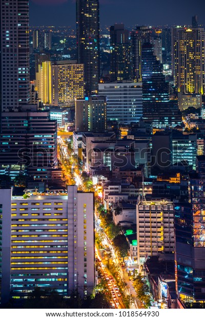 Top
View of City Road and Bangkok Cityscape with Car Traffic Light
Trial at Night Time, Thailand. Portrait
Orientation.