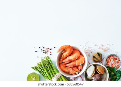 Top View Of Clean Eating Ingredients Over White Background With A Copy Space. Cooked Prawns, Clamps, Asparagus, Lime, Salt And Pepper.