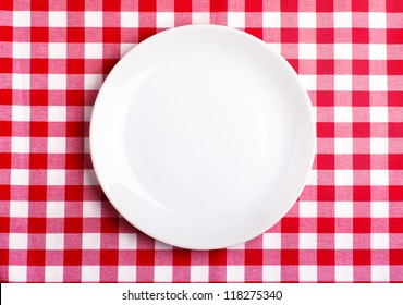 Top View Of Clean White Plate On A Tablecloth