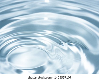 top view Close Up blue water rings, clear water, Close-up water droplets affect the surface splash in the pool, forming rings on the surface. reflections in blue water. - Shutterstock ID 1403557109