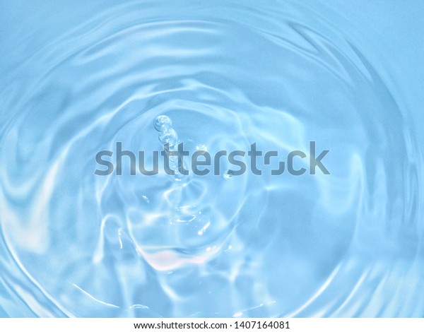 top view Close Up\
blue water rings, clear water, Close-up water droplets affect the\
surface splash in the pool, forming rings on the surface.\
reflections in blue water.